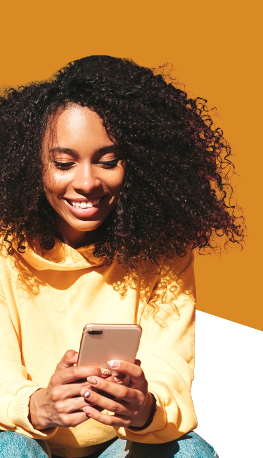Smiling woman student successfully learning Amharic online with a laptop